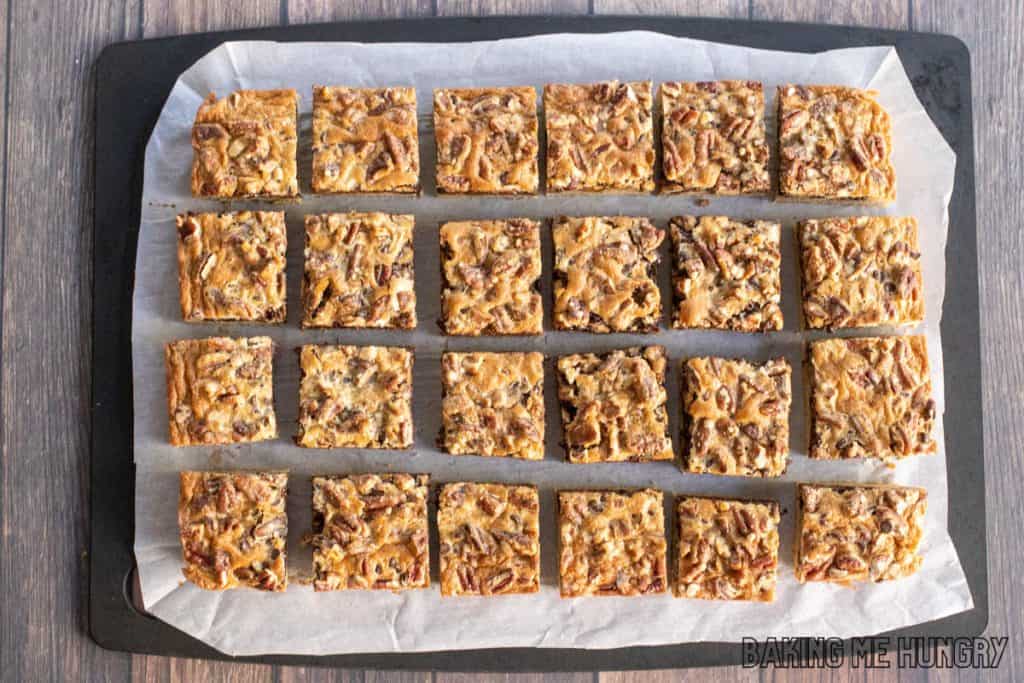 chocolate pecan bars cut into squares on a cutting board