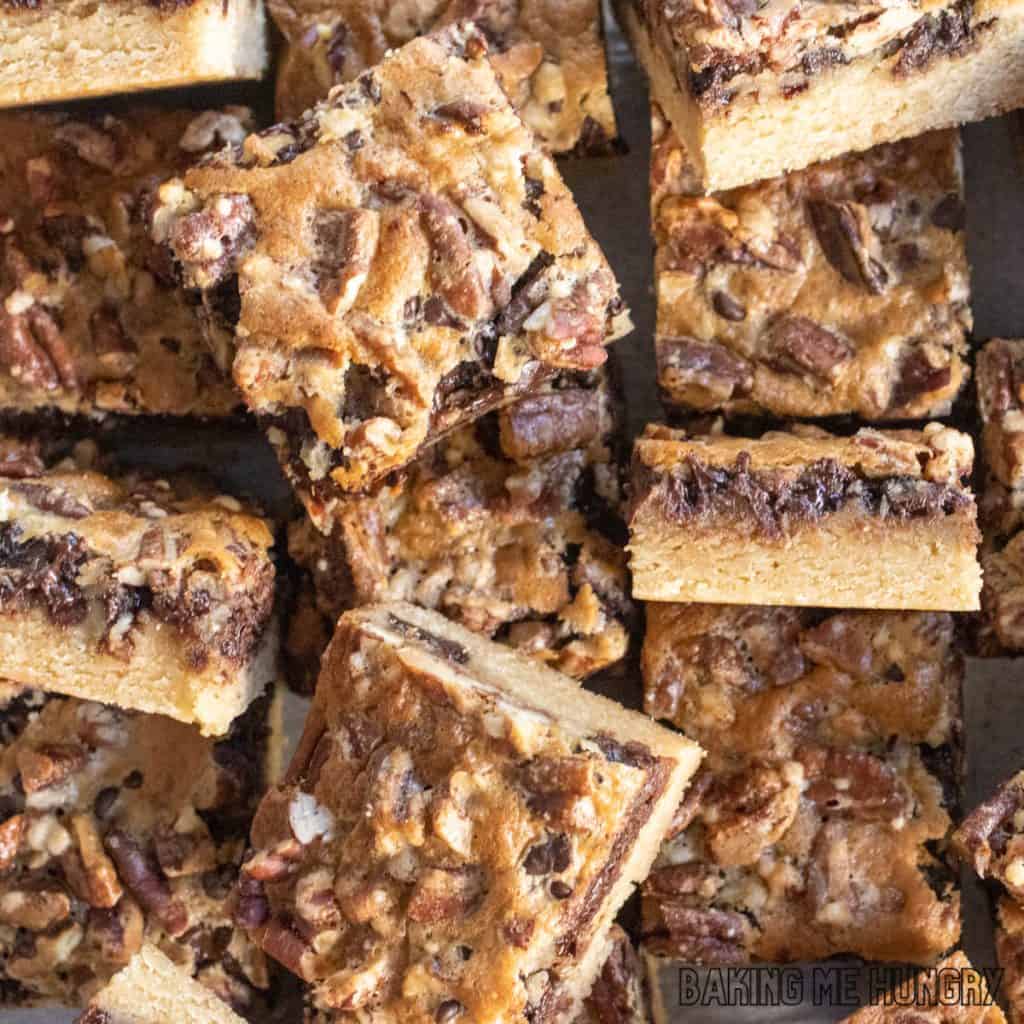 chocolate pecan pie bars haphazard on a cutting board