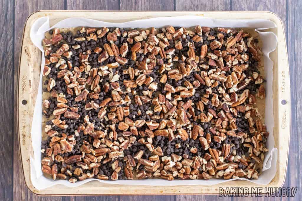 chocolate chips and pecans on crust