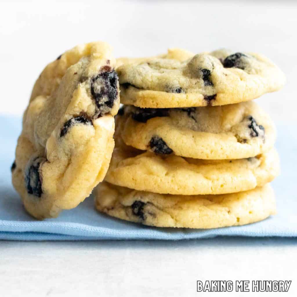 blueberry white chocolate cookies in a stack with one on its side