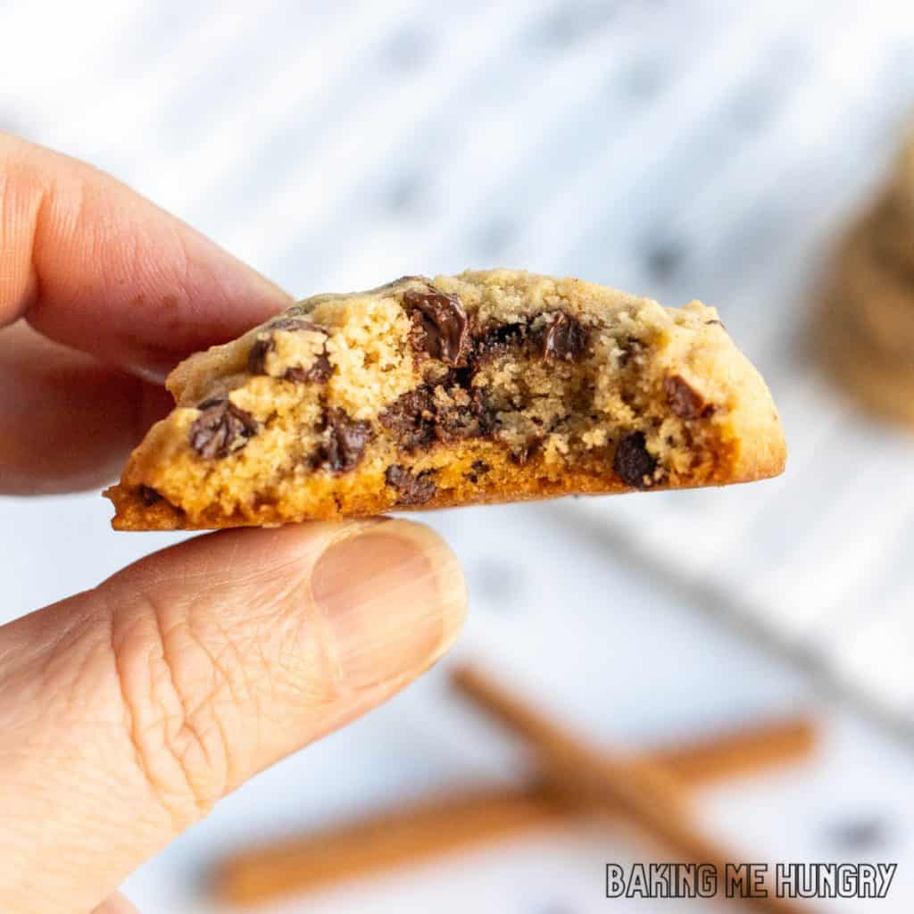 hand holding one of the chocolate chip cinnamon cookies missing a bite