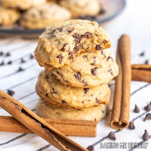 cinnamon chocolate chip cookies in a tall stack with top cookie missing a bite