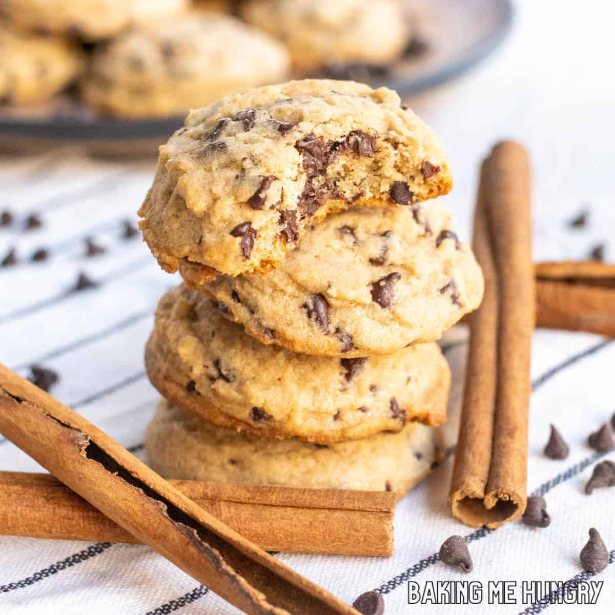 cinnamon chocolate chip cookies in a tall stack with top cookie missing a bite