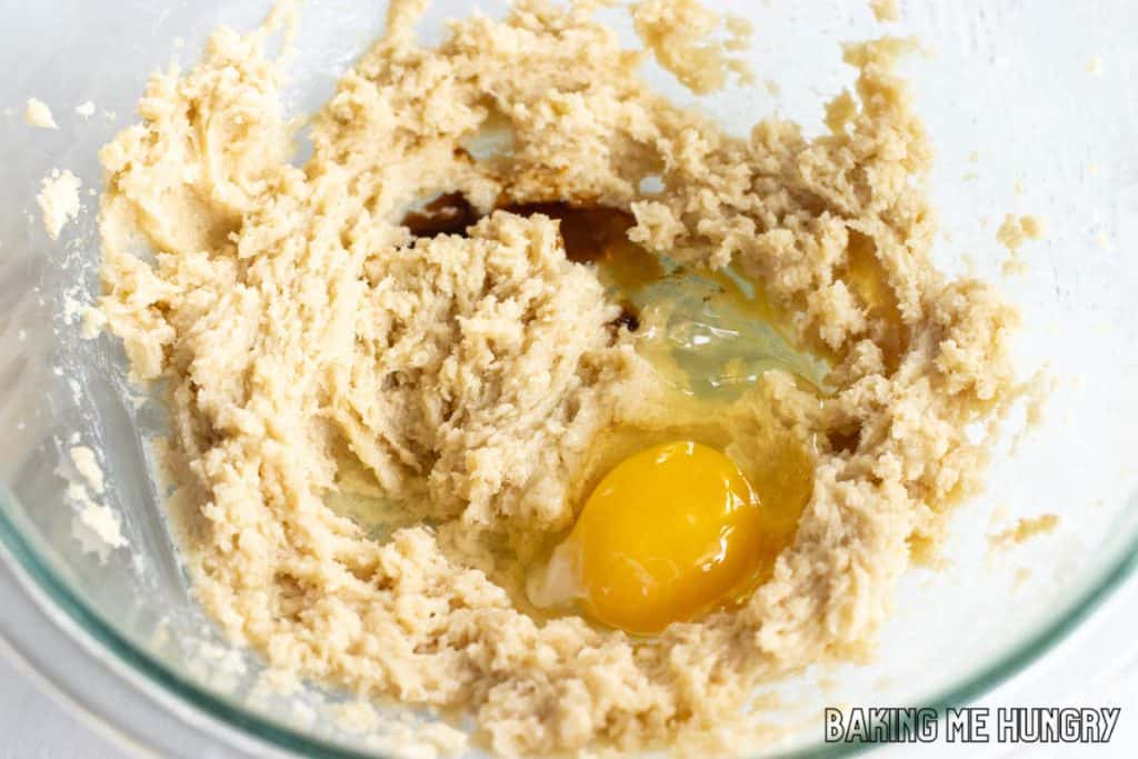 creamed butter and sugar in bowl with egg and vanilla