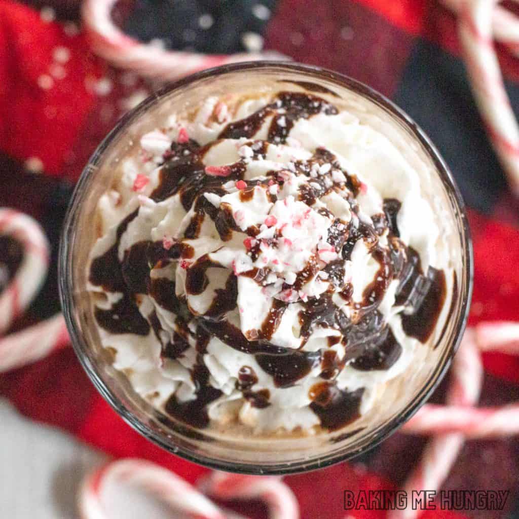 iced peppermint mocha topped with whipped cream, chocolate sauce, and crushed candy canes close up