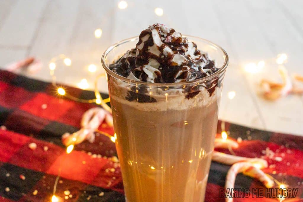iced peppermint mocha glass in front of twinkle lights