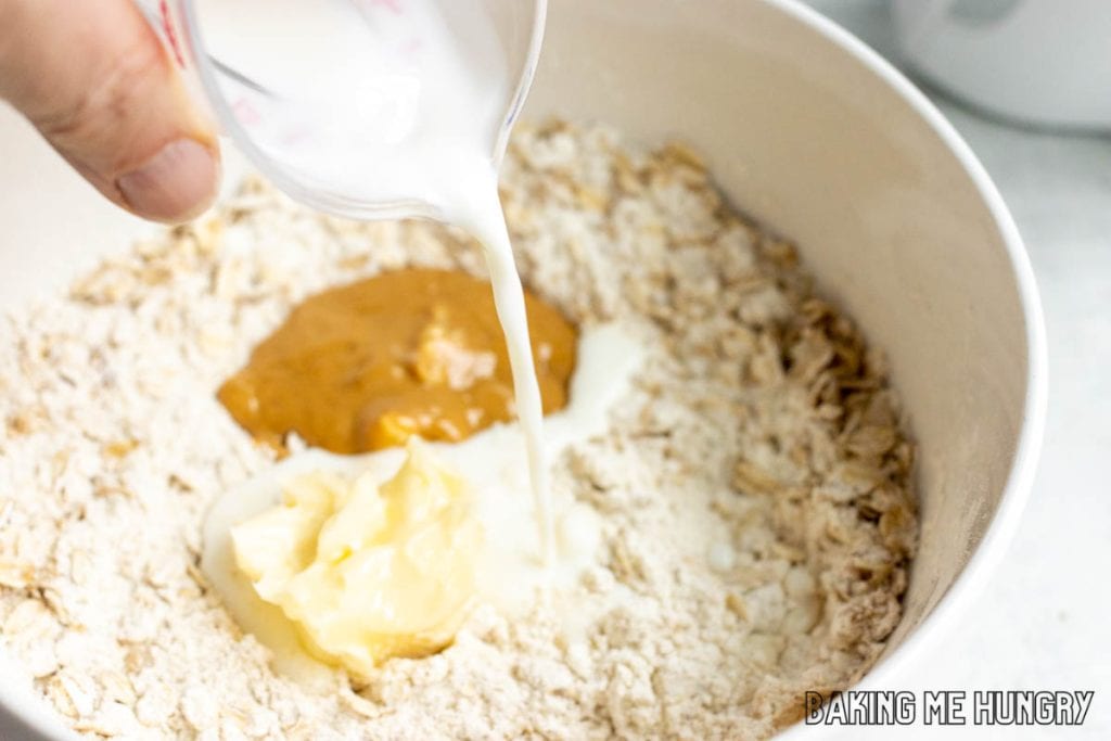 hand pouring milk into bowl