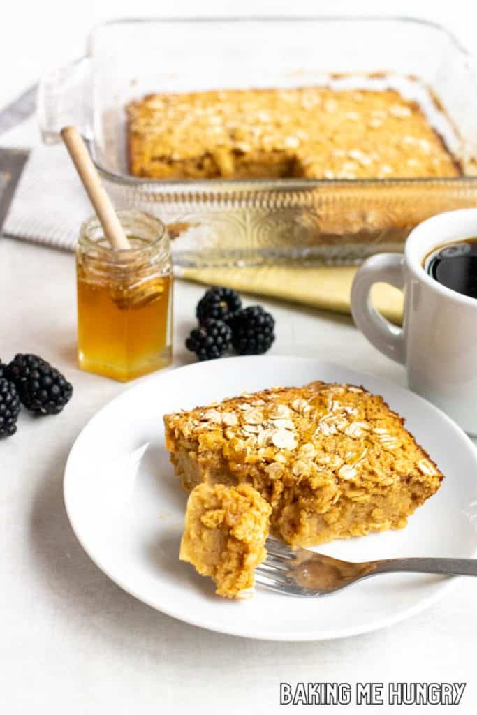peanut butter baked oats on a plate with coffee and baking dish behind