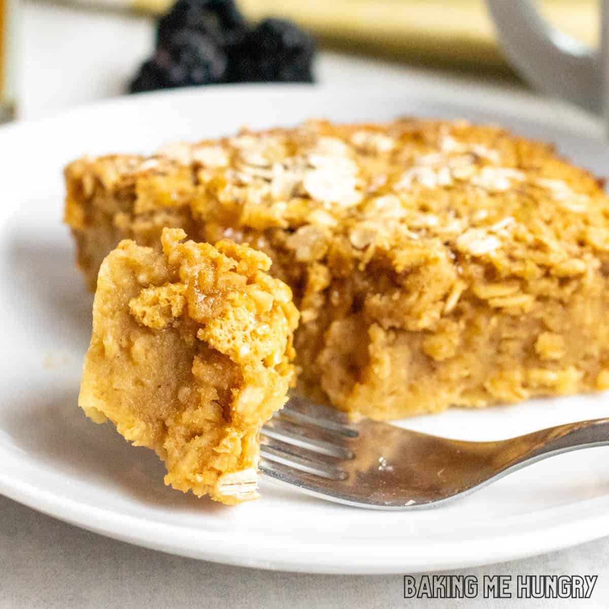 peanut butter baked oats on a plate with a bite on a fork close up
