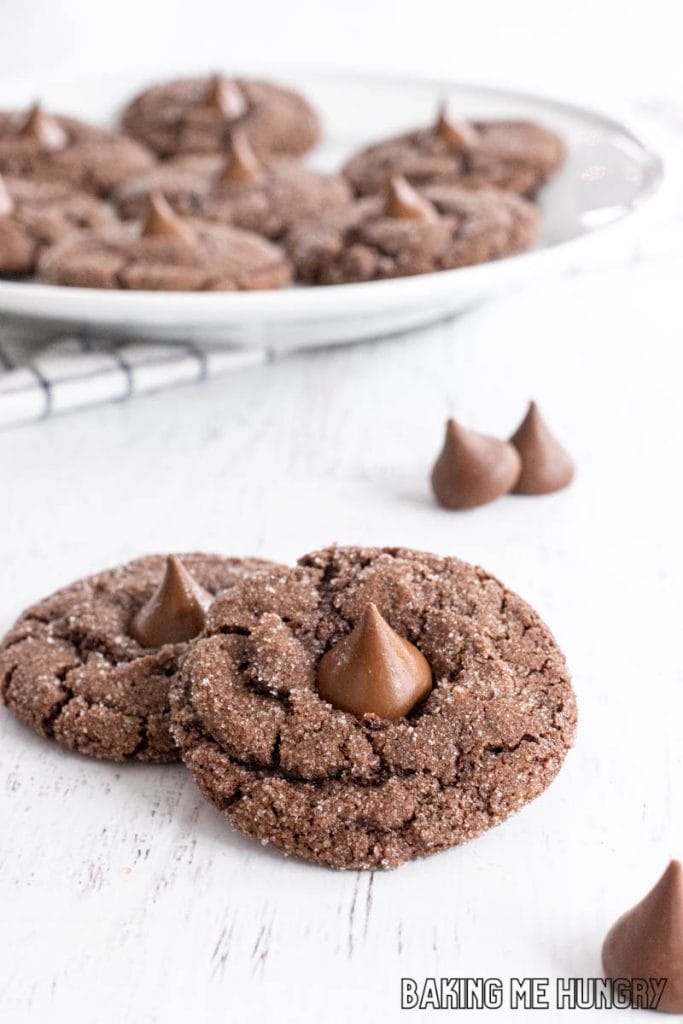 cocoa blossom cookies on white background with plate behind