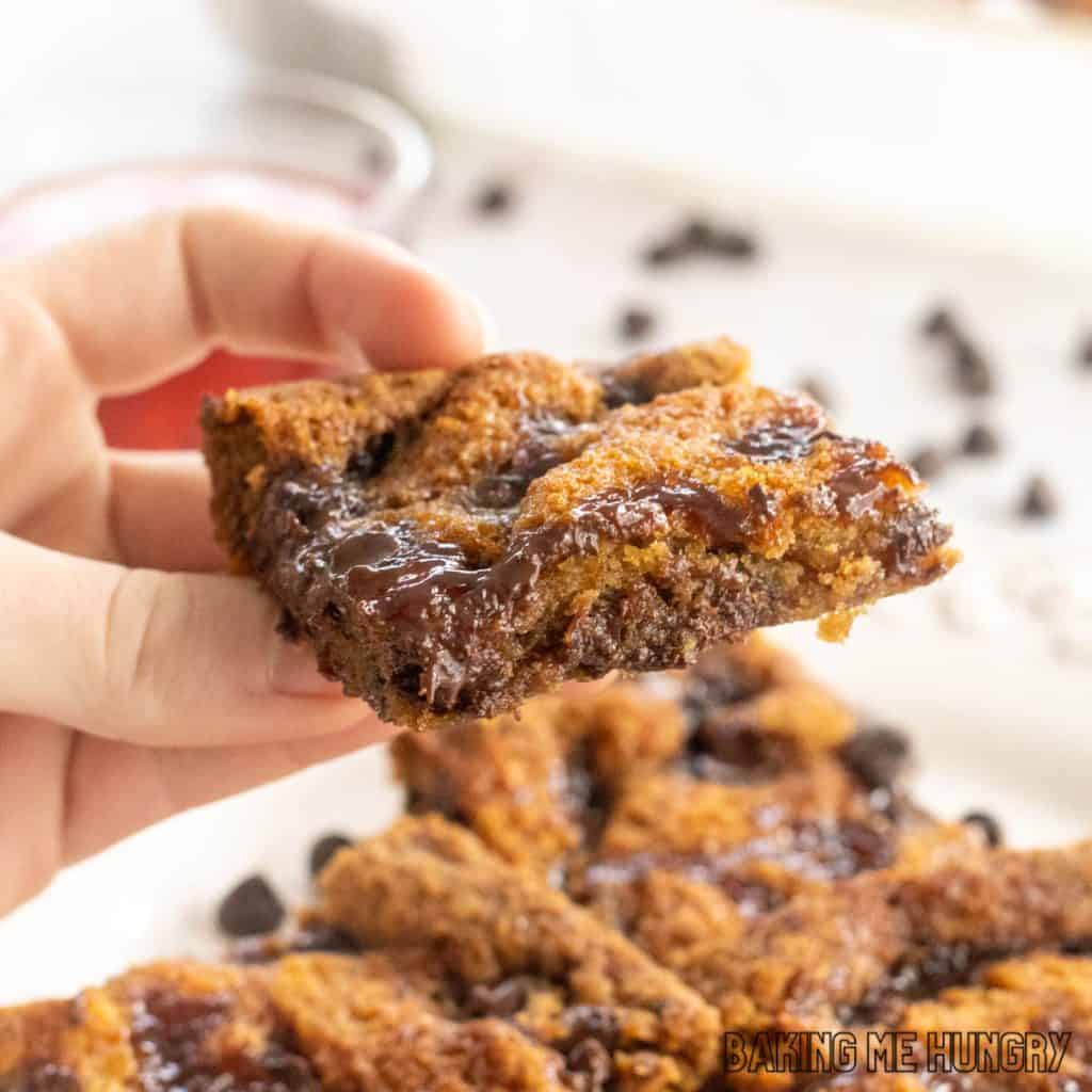 hand holding one of the dark chocolate raspberry blondies