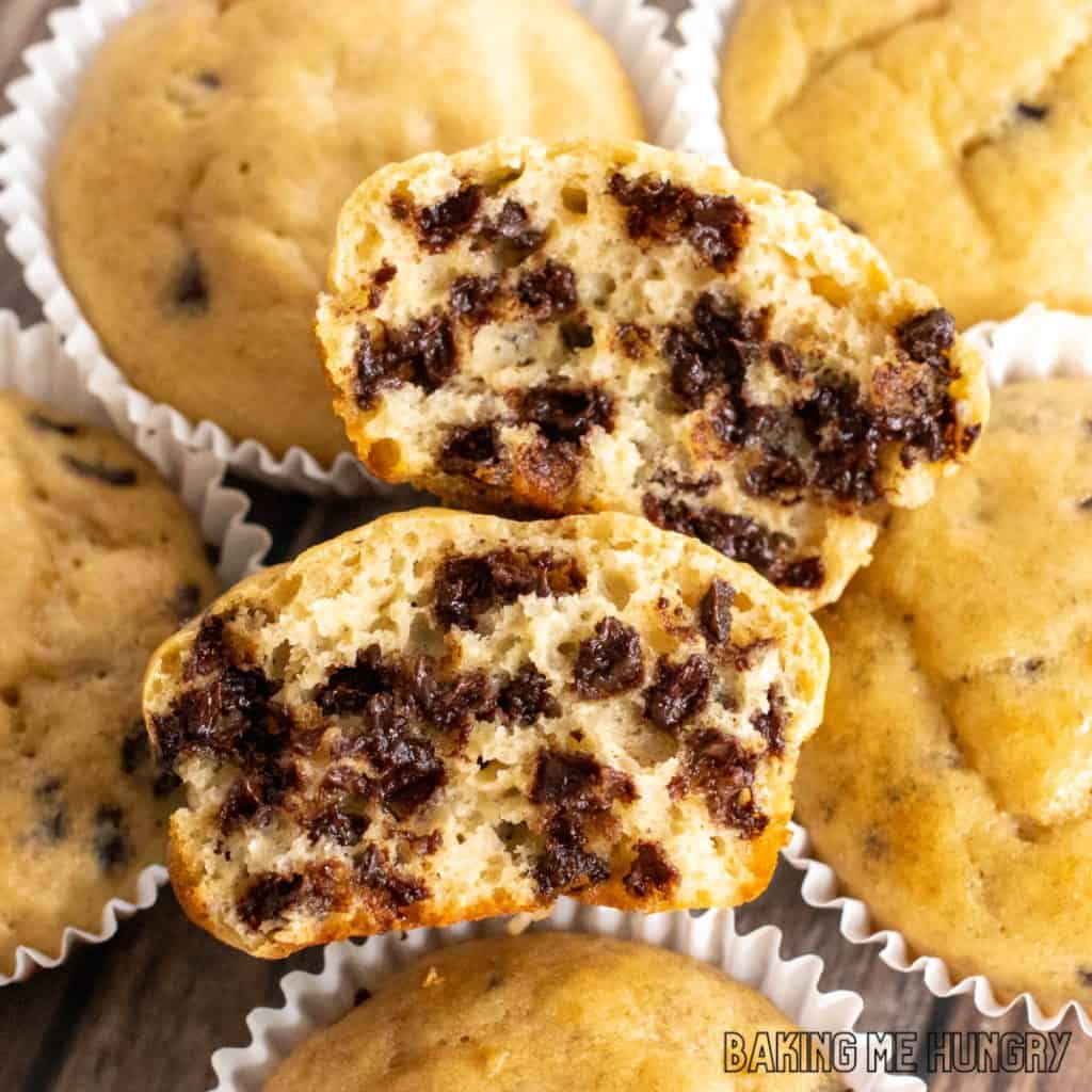 kodiak cake muffins recipe with one broken in half on top of pile showing moist interior close up