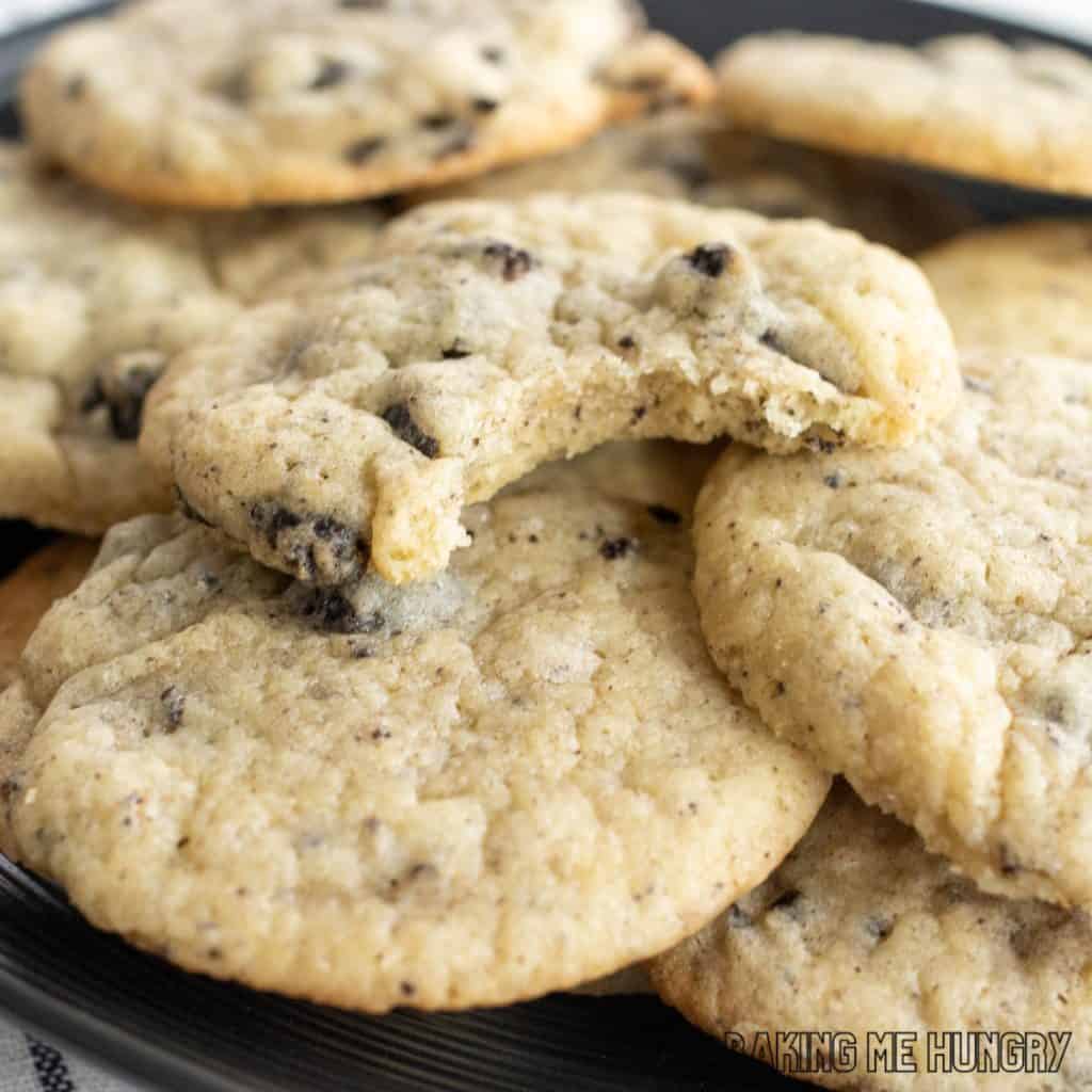 cookies and cream sugar cookies on a plate with one cookie missing a bite