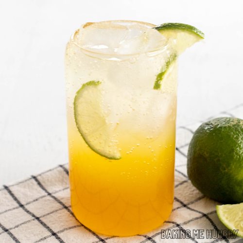 passion fruit mocktail recipe in a tall glass with lime slices