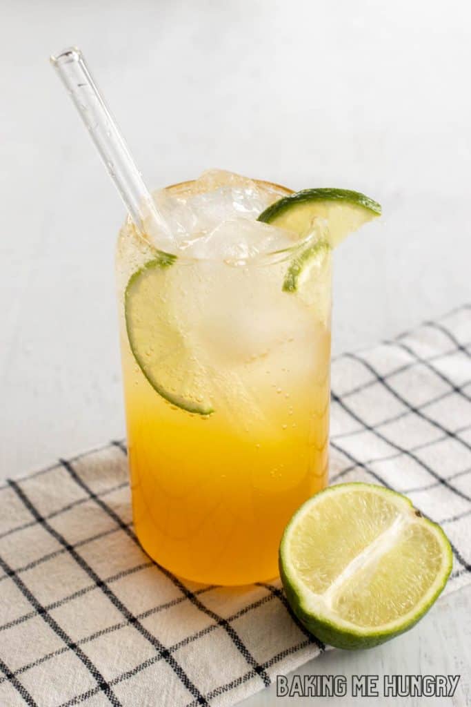 passion fruit mocktail recipe in a tall glass with a glass straw
