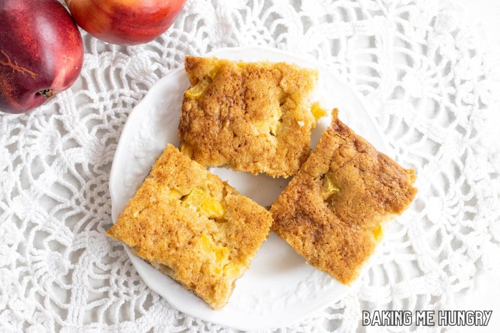 three peach blondies on white plate from overhead