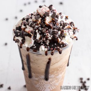 peppermint mocha frappuccino recipe in Starbucks cup topped with whipped cream, crushed candy canes, and mini chocolate chips