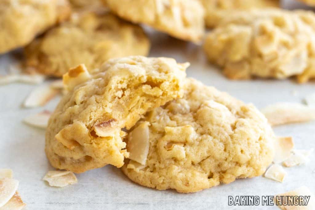 pineapple coconut cookies on white backdrop with one missing a bite