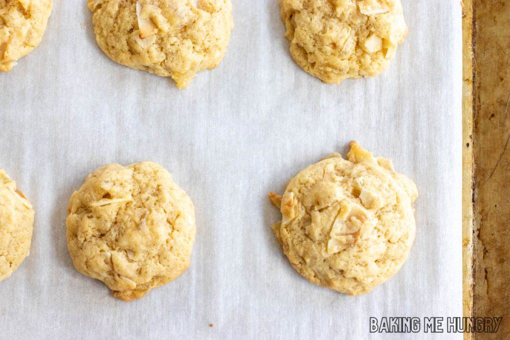 pineapple coconut cookies on parchment paper on baking sheet