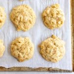 pineapple coconut cookies on parchment paper on baking sheet close up