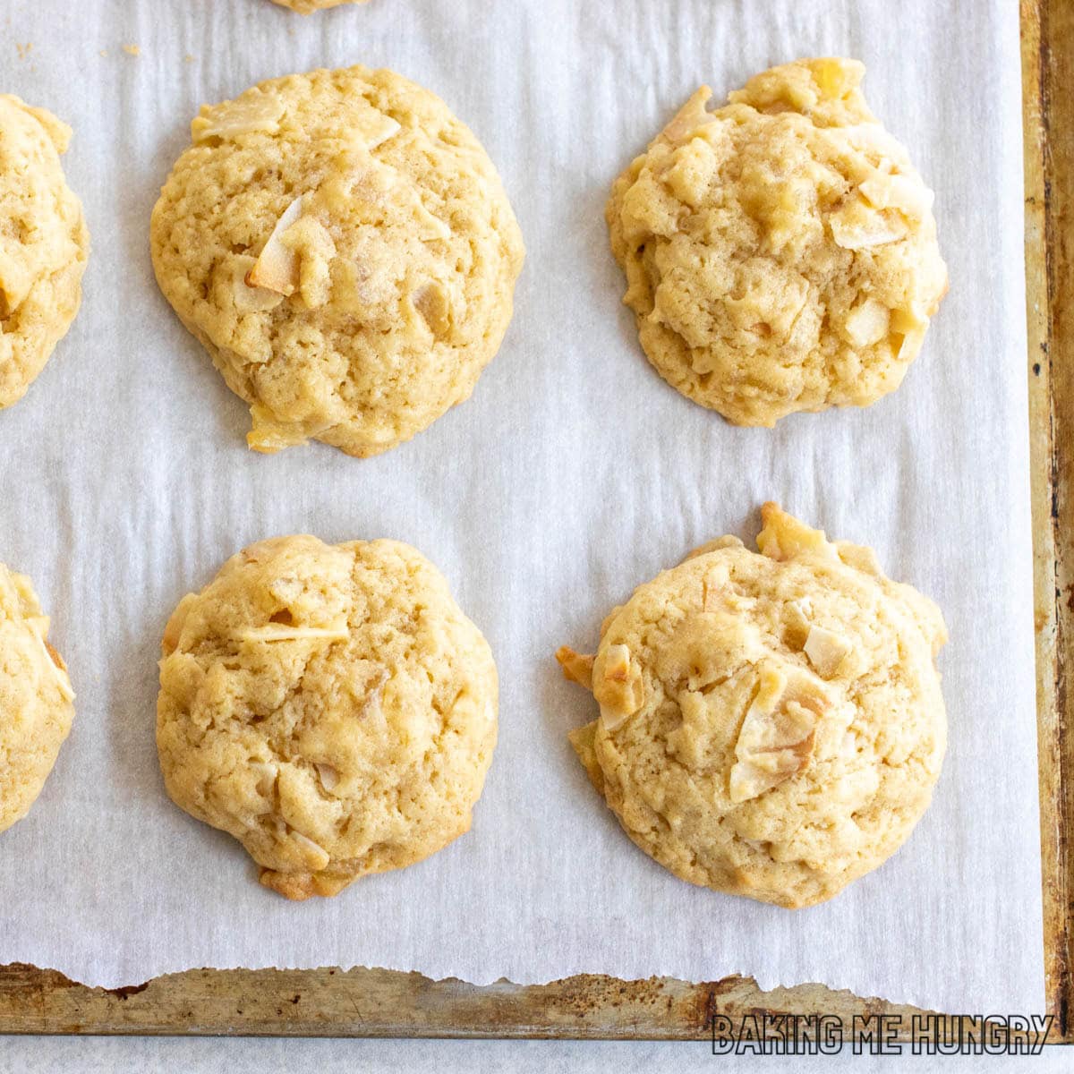 pineapple coconut cookies on parchment paper on baking sheet close up