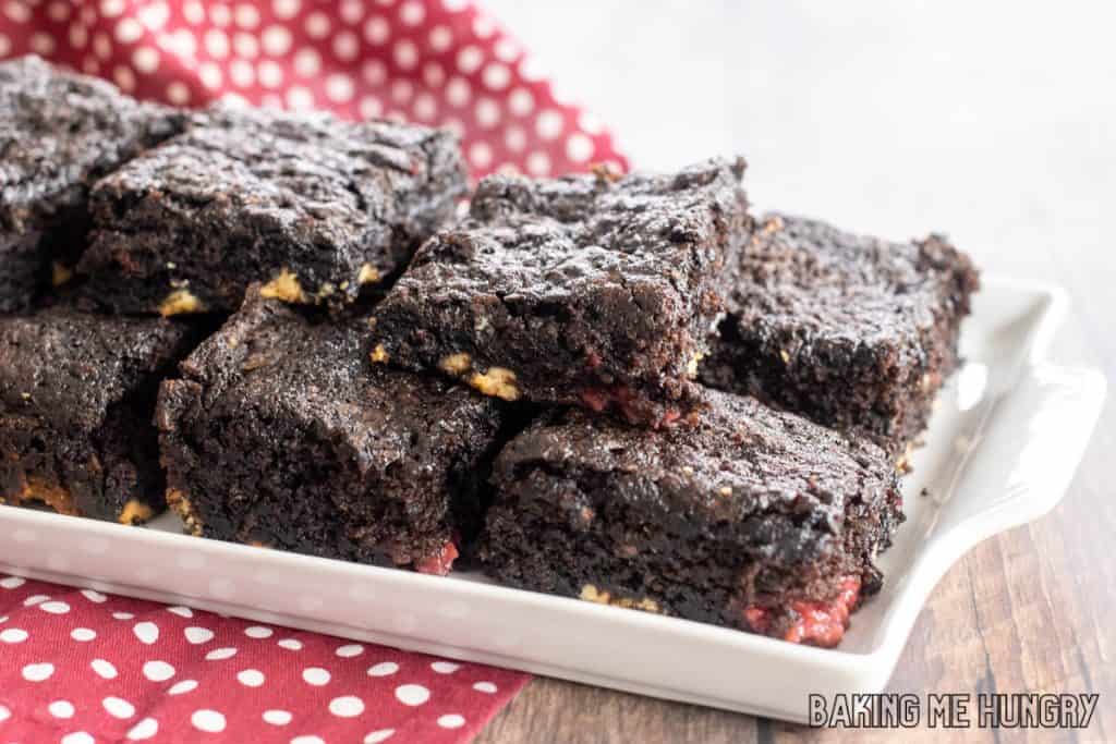 white chocolate raspberry brownies on a white plate