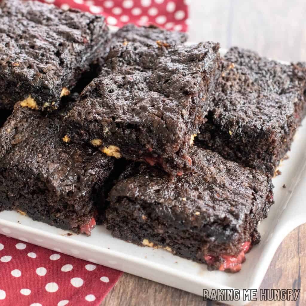 white chocolate raspberry brownies recipe on a white servings platter close up
