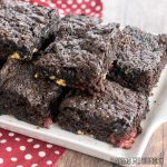 white chocolate raspberry brownies recipe on a white servings platter close up
