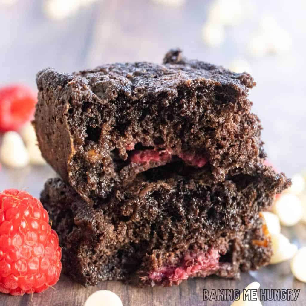 close up of two halves of the white chocolate raspberry brownies stacked