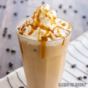 caramel iced coffee recipe topped with whipped cream and caramel syrup close up in glass