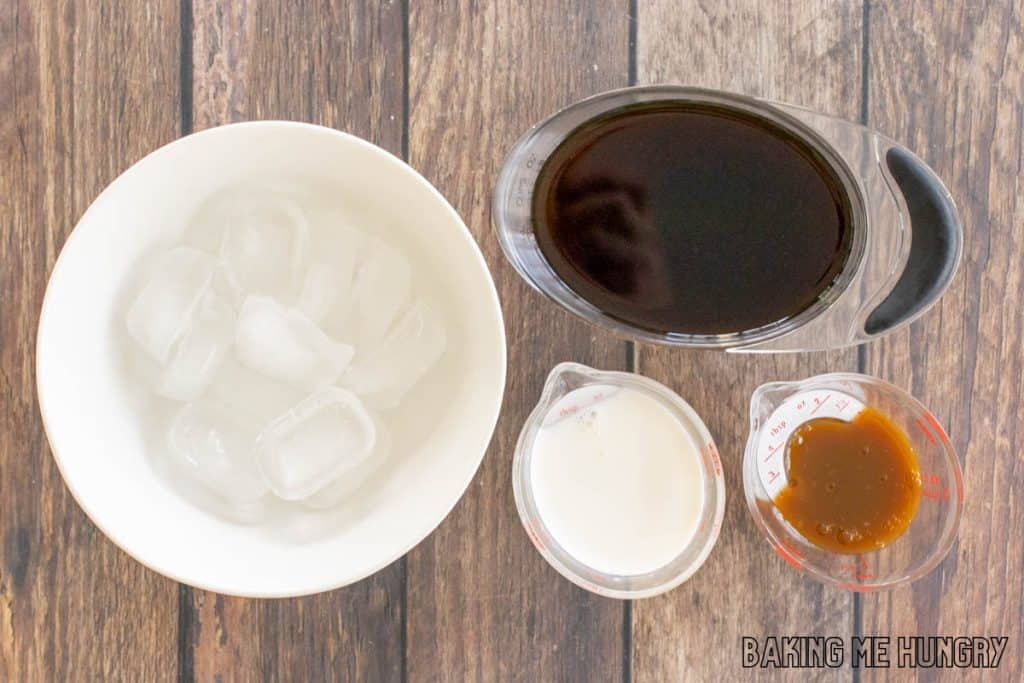 ingredients in small measuring cups next to bowl of ice