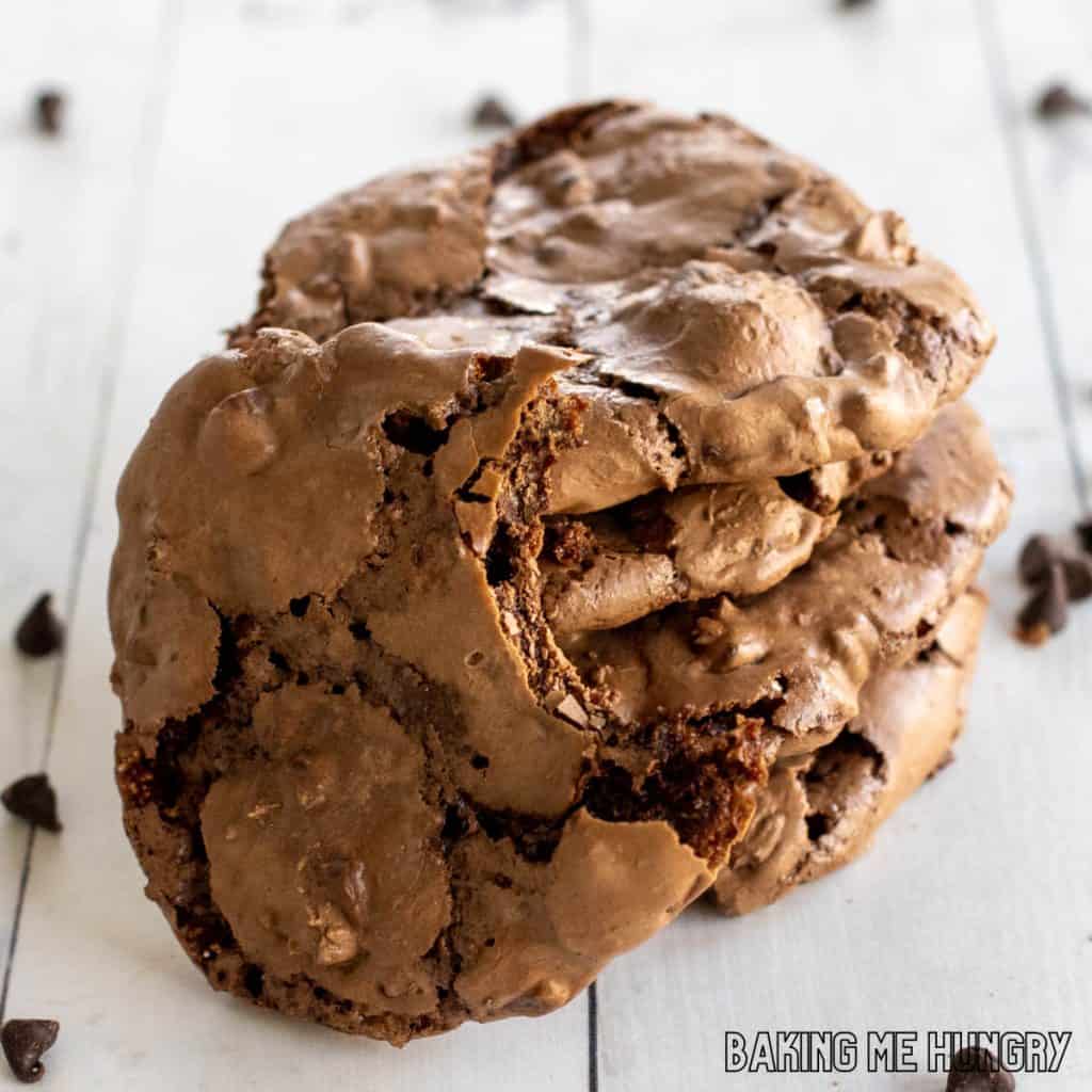 fudgy chocolate cookies in a pile with one missing a bite