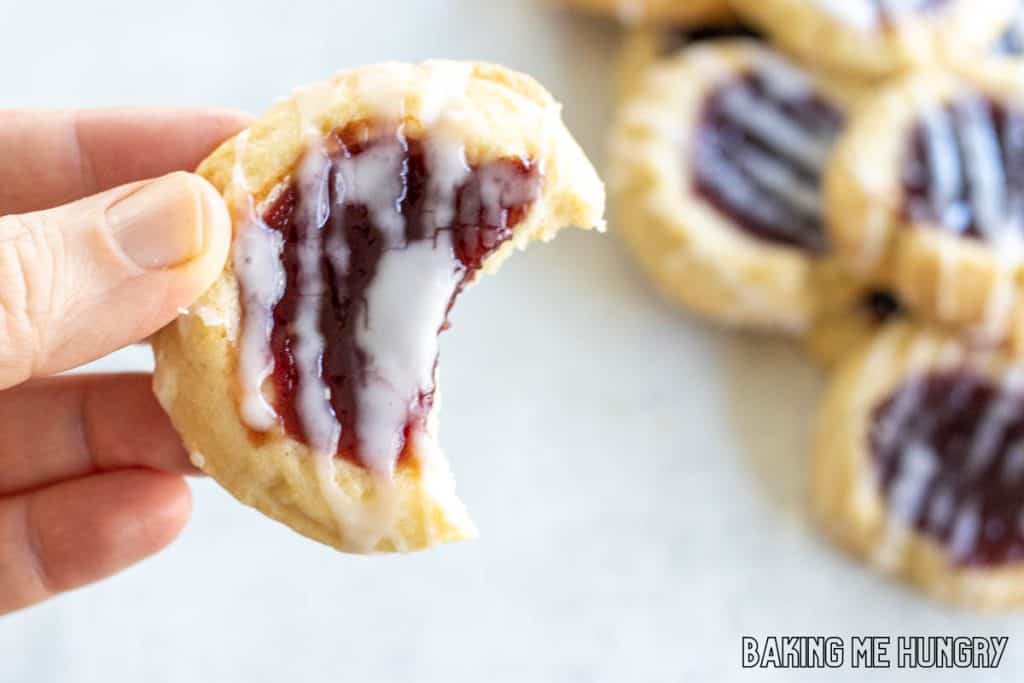 hand holding one of the lemon cookies with a bite missing