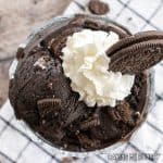 oreo ice cream recipe in bowl with whipped cream and cookie crumbs on top close up