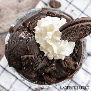 oreo ice cream recipe in bowl with whipped cream and cookie crumbs on top close up