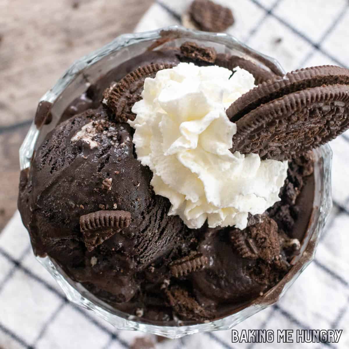 oreo ice cream recipe in bowl with whipped cream and cookie crumbs on top close up