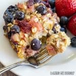 baked rhubarb oatmeal on small plate with bite on a fork close up