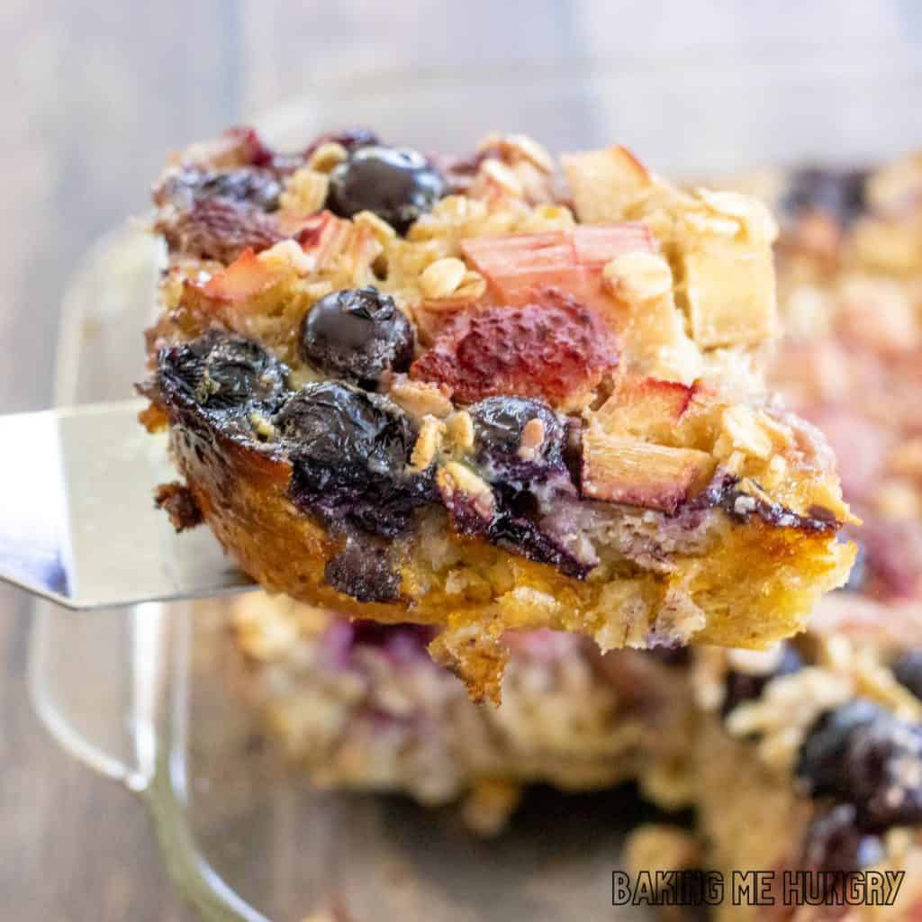baked rhubarb oatmeal piece being lifted with serving spatula