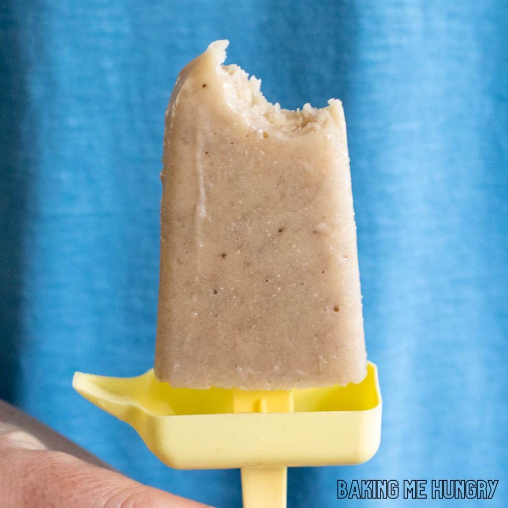 creamy banana popsicles recipe one of the creamy banana popsicles held up missing a bite