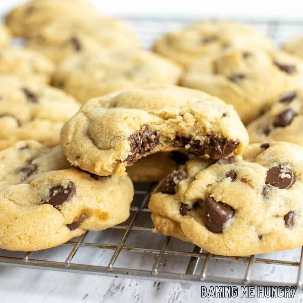 one of the brown sugar chocolate chip cookies missing a bite on pile of cookies