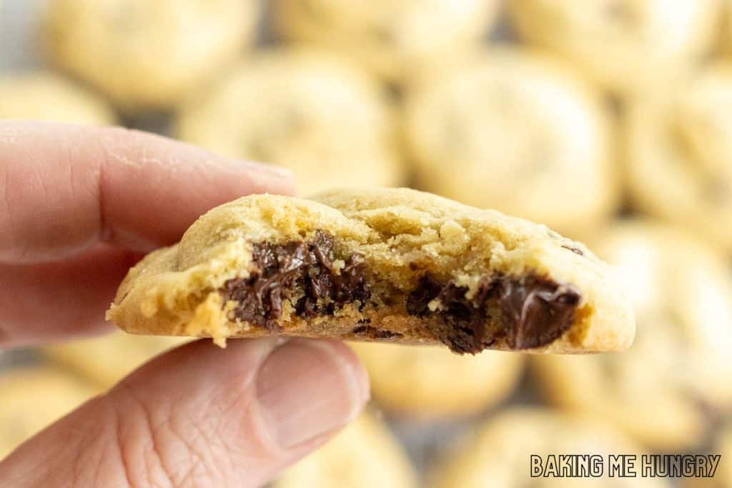 hand holding up one of the brown sugar chocolate chip cookies with a bite missing
