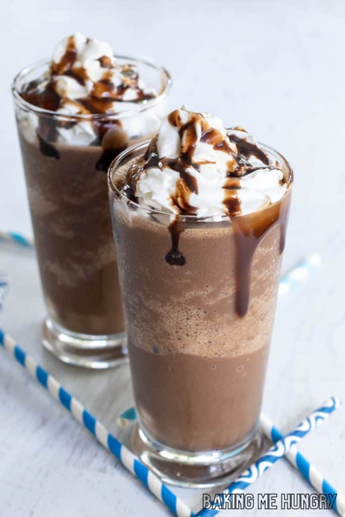 chocolate slushy recipe in two glasses with whipped cream and chocolate syrup
