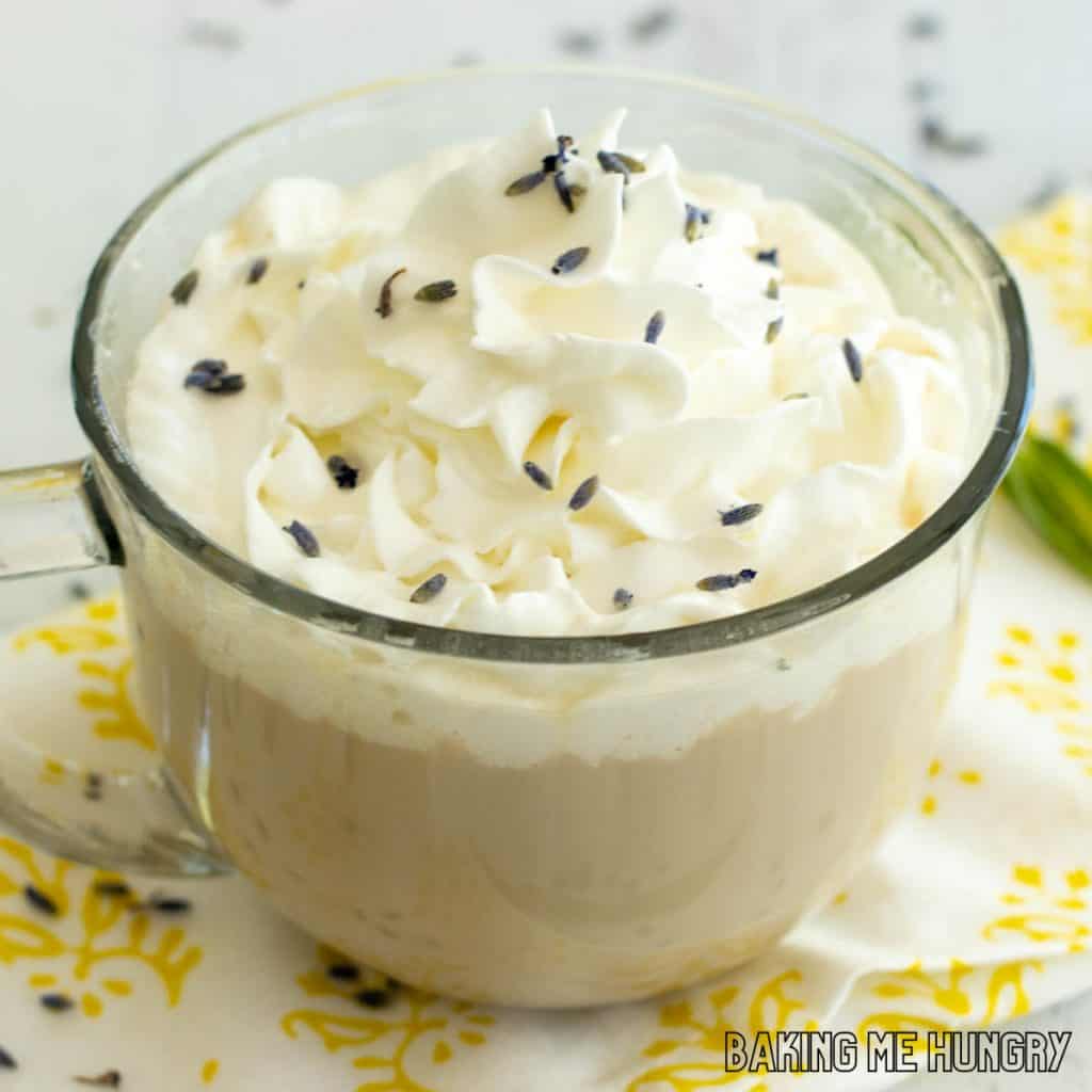 lavender latte recipe in wide glass mug sprinkled with lavender blossoms
