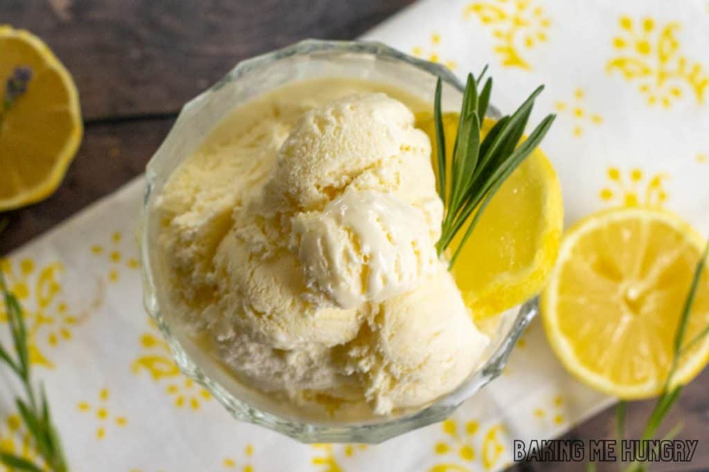lavender lemonade ice cream in a glass bowl from overhead garnished with lemon slices and fresh lavender