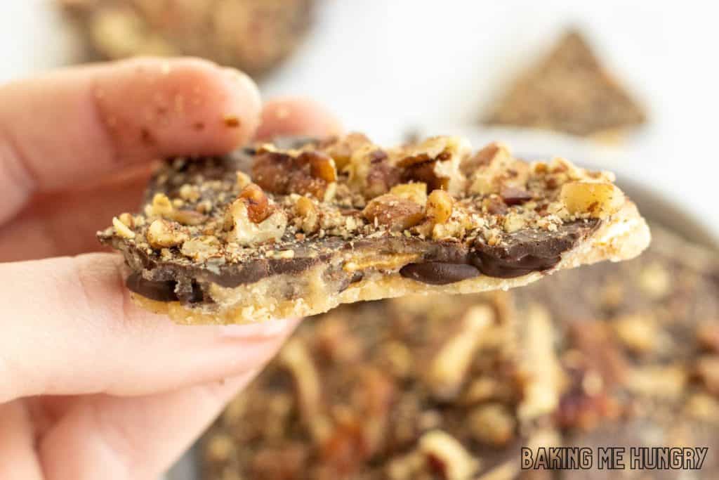 hand holding up a piece of the pretzel crack recipe