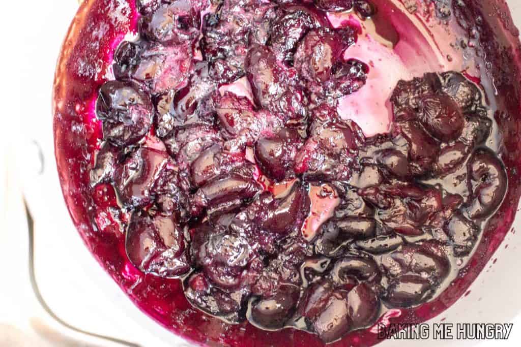 cooked cherries and syrup in pot