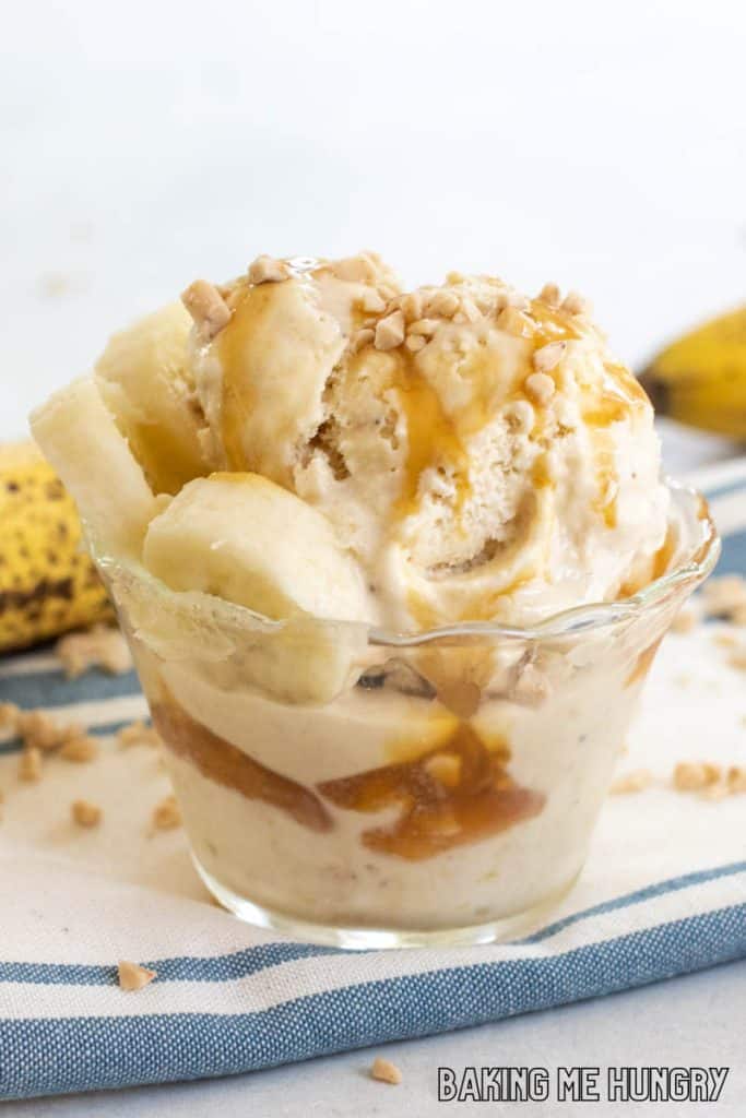 banoffee ice cream in small dish with caramel sauce, banana slices, and toffee bits