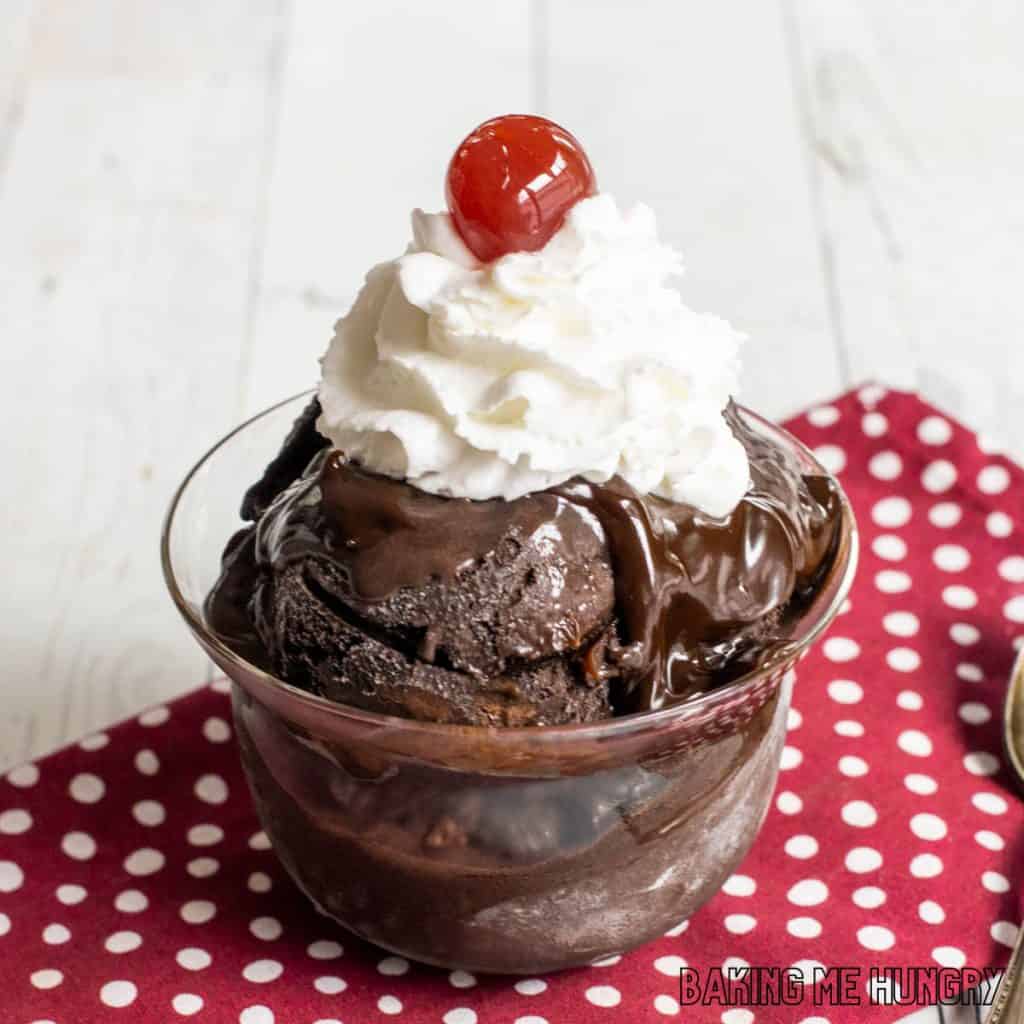 brownie batter ice cream recipe in dish with whipped cream and a cherry