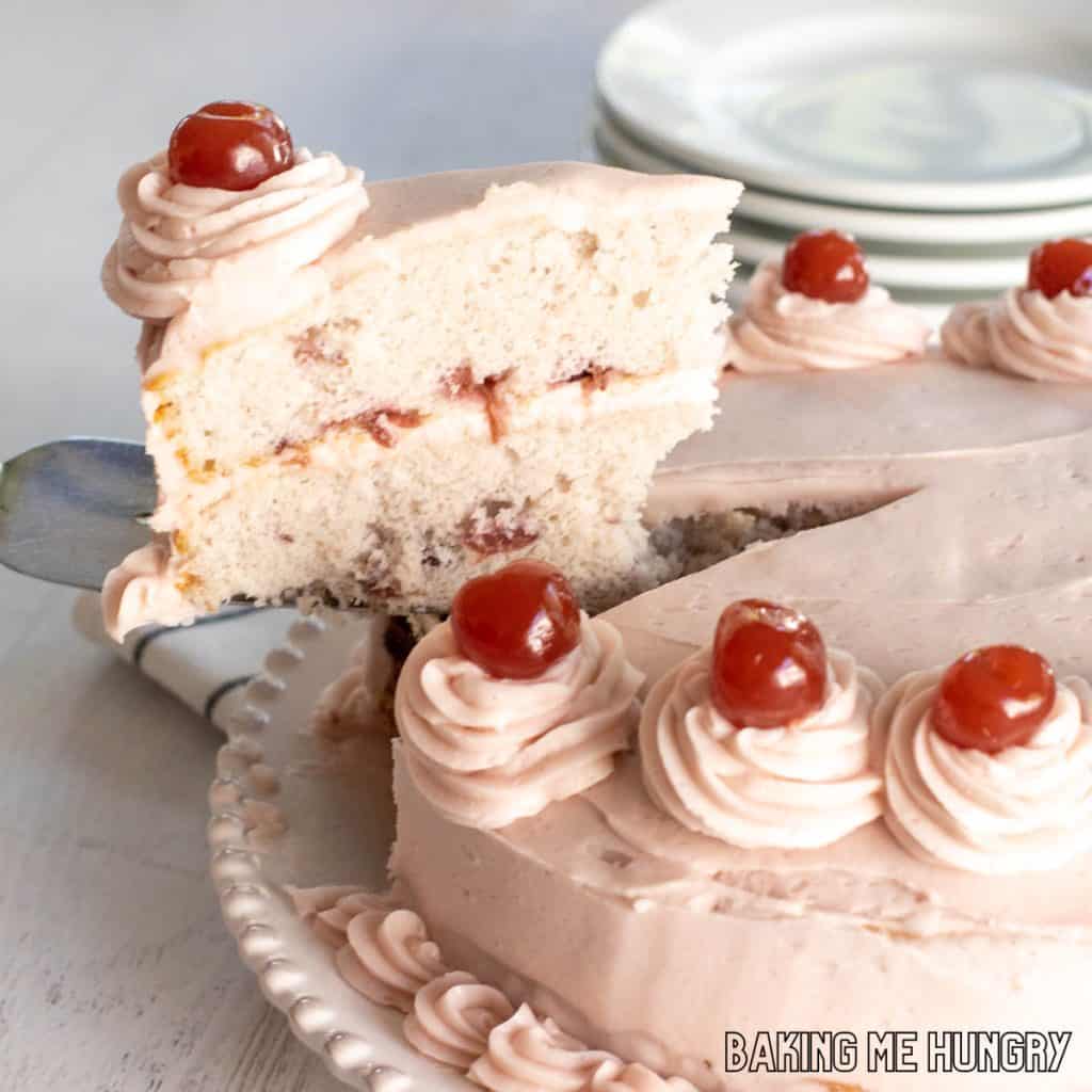 cherry chip cake recipe slice being lifted from platter with cake slicer close up