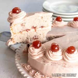 cherry chip cake recipe slice being lifted from platter with cake slicer close up